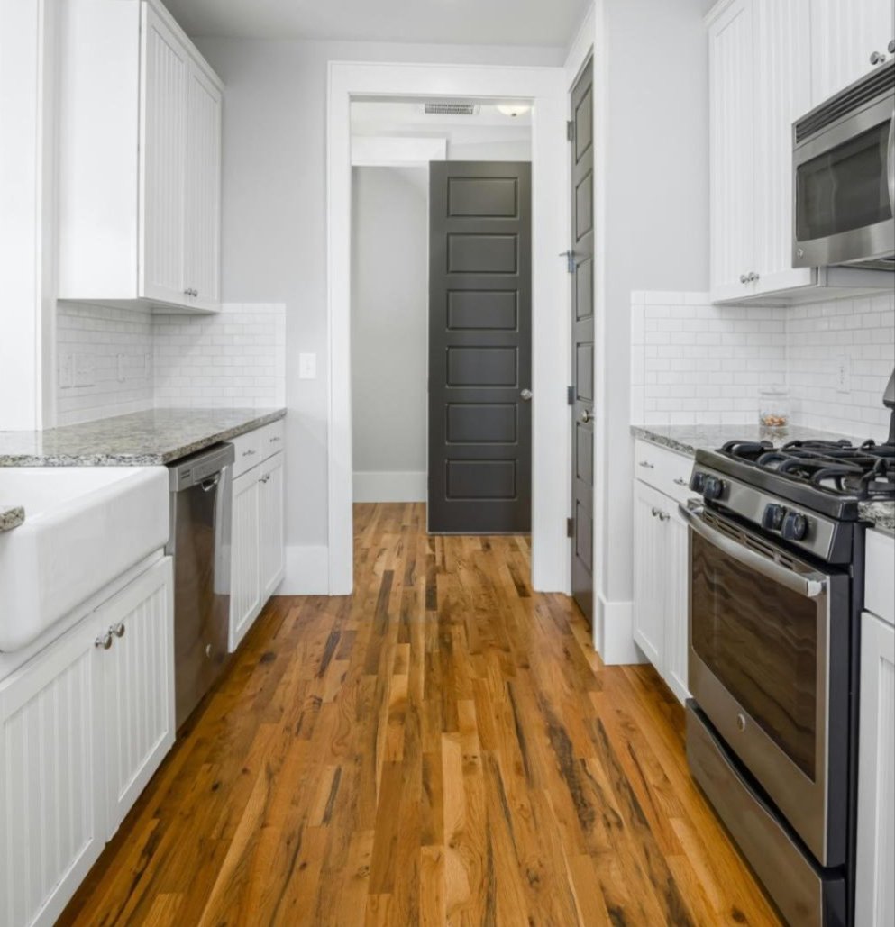 Kitchen featuring solid and engineered hardwood flooring options in Houston, TX — Tile Zone helps homeowners compare durability, style, and performance