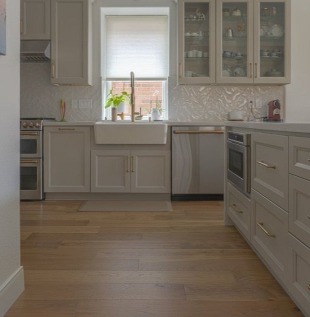 Modern kitchen featuring professionally installed hardwood flooring in Houston, TX — Tile Zone specializes in timeless flooring solutions for homes and businesses across Southeast Texas