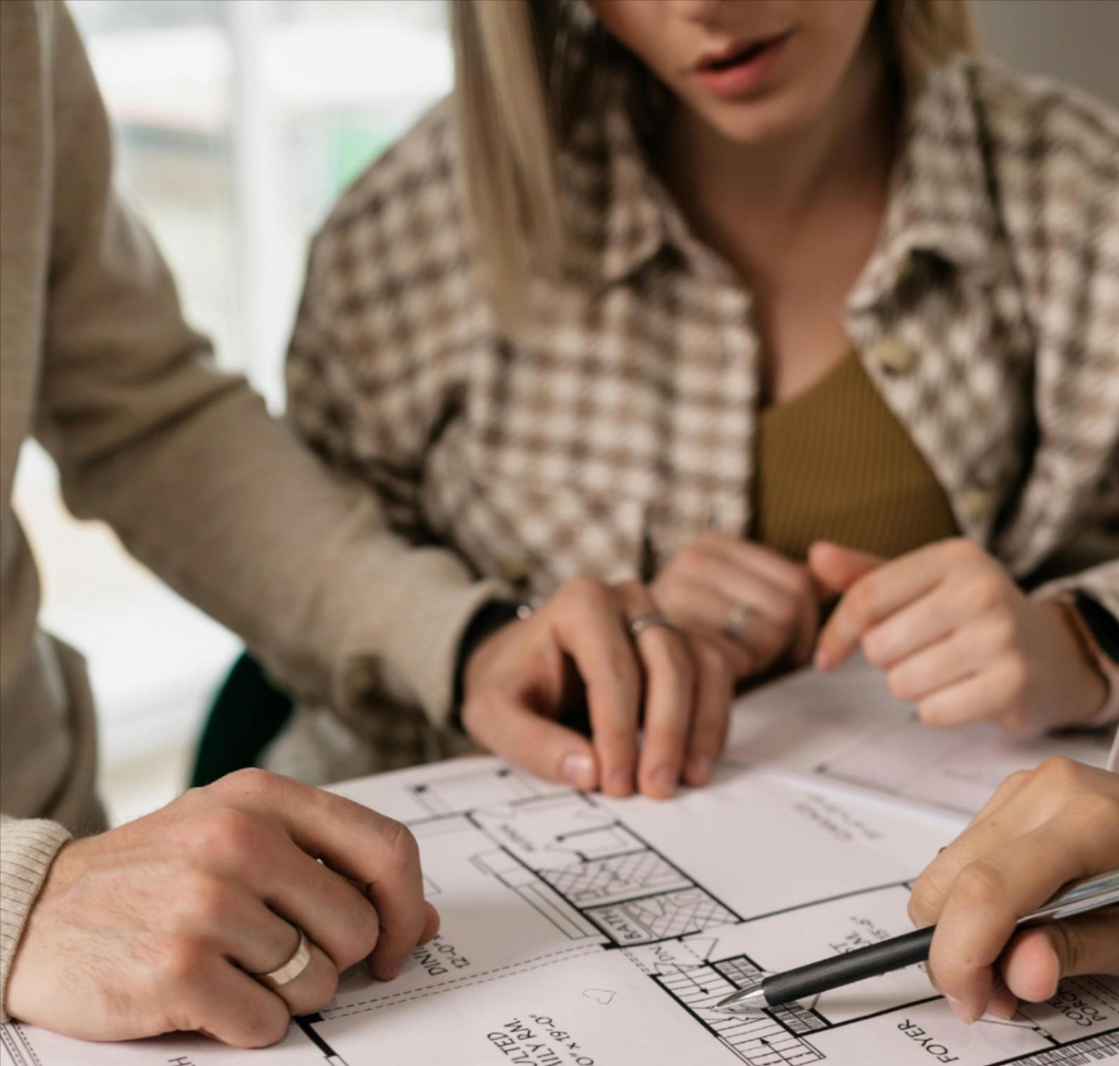 Homeowners reviewing remodeling plans with a Tile Zone designer in Houston, TX — schedule a free flooring or renovation consultation with our in-house team
