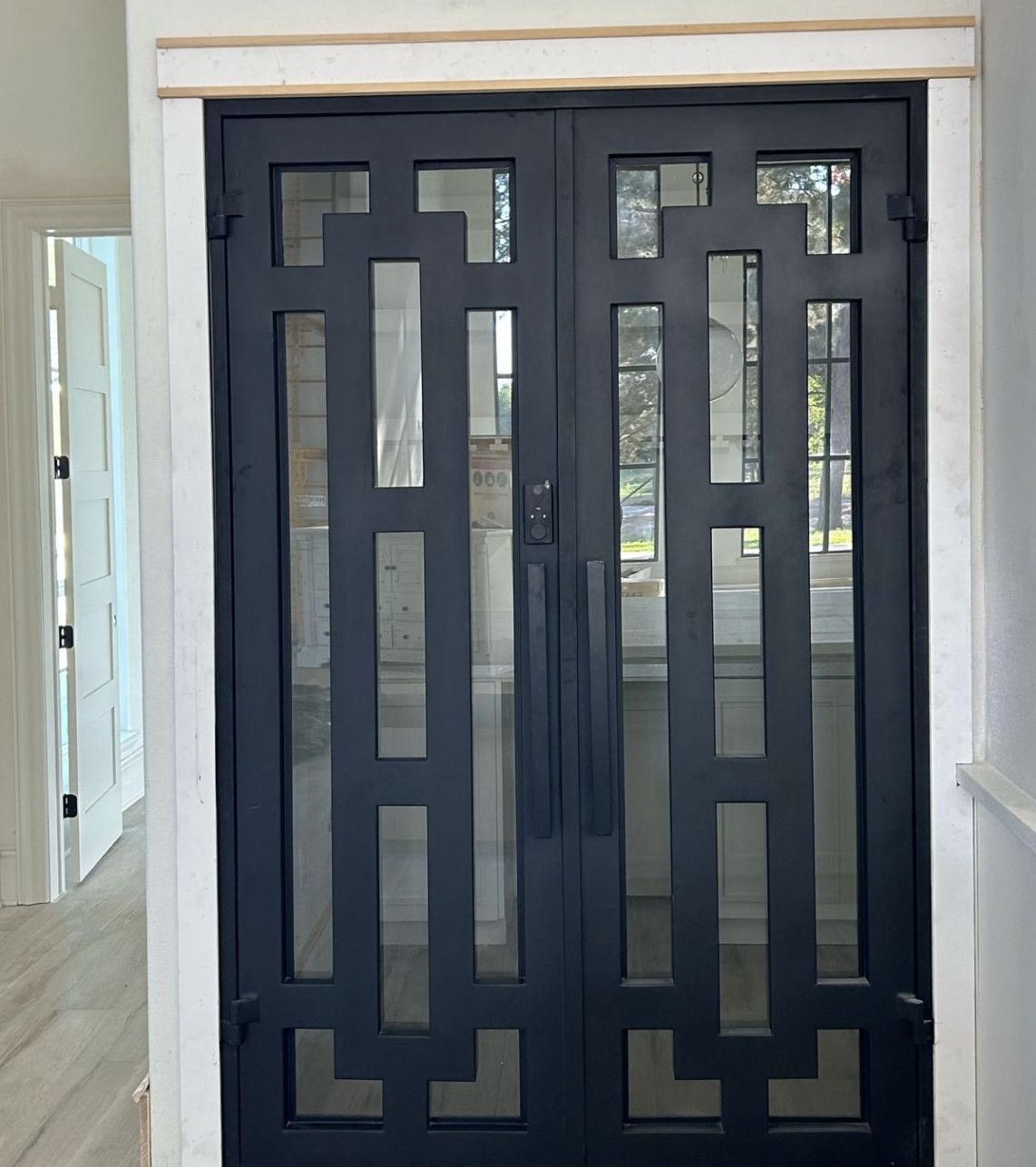 Tile Zone custom iron doors in Houston, TX — elegant glass and iron designs that enhance security, beauty, and value for modern homes