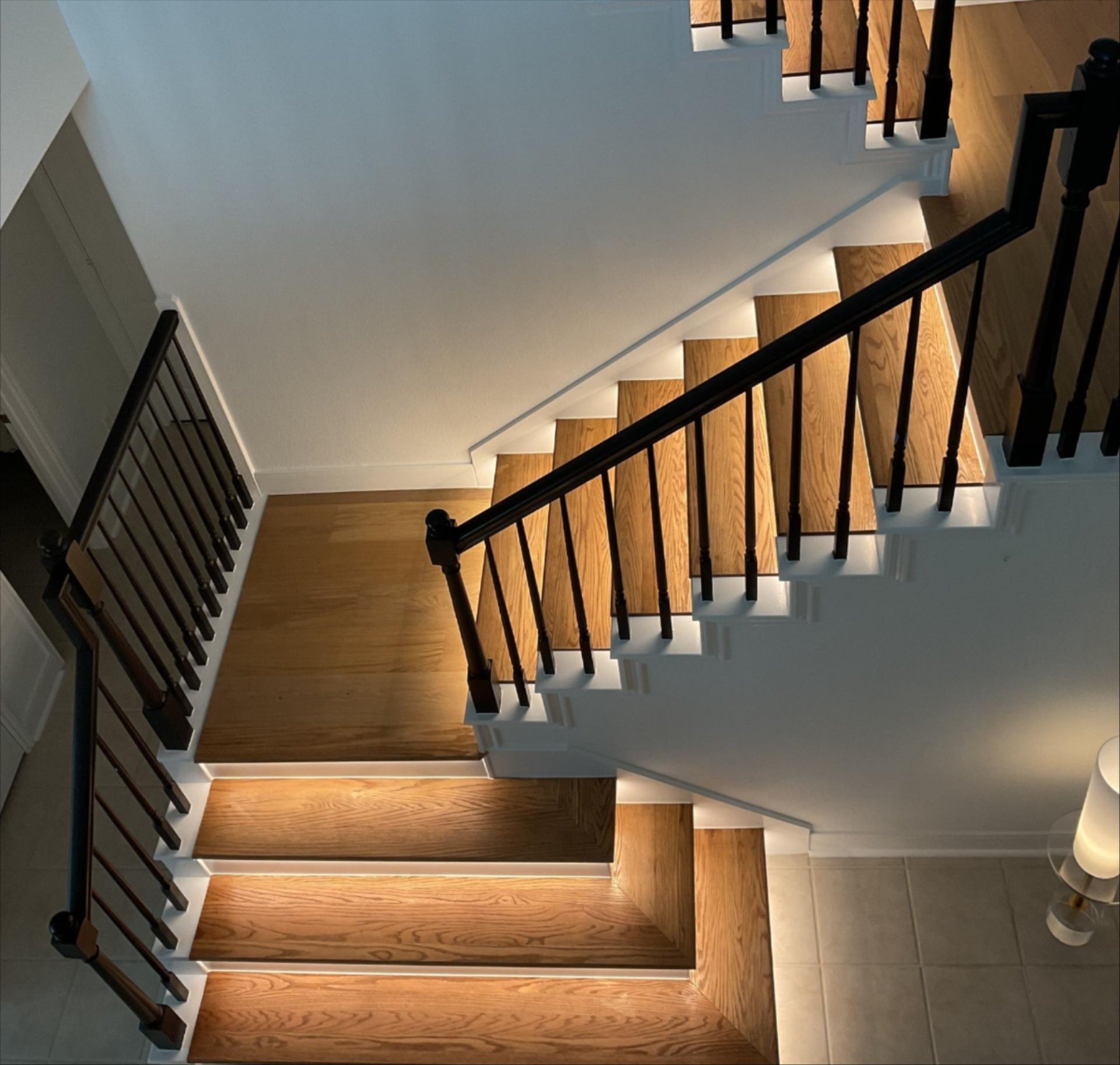 Modern staircase with newly refinished hardwood steps in Houston, TX — Tile Zone provides expert staircase installation, refinishing, and custom woodwork