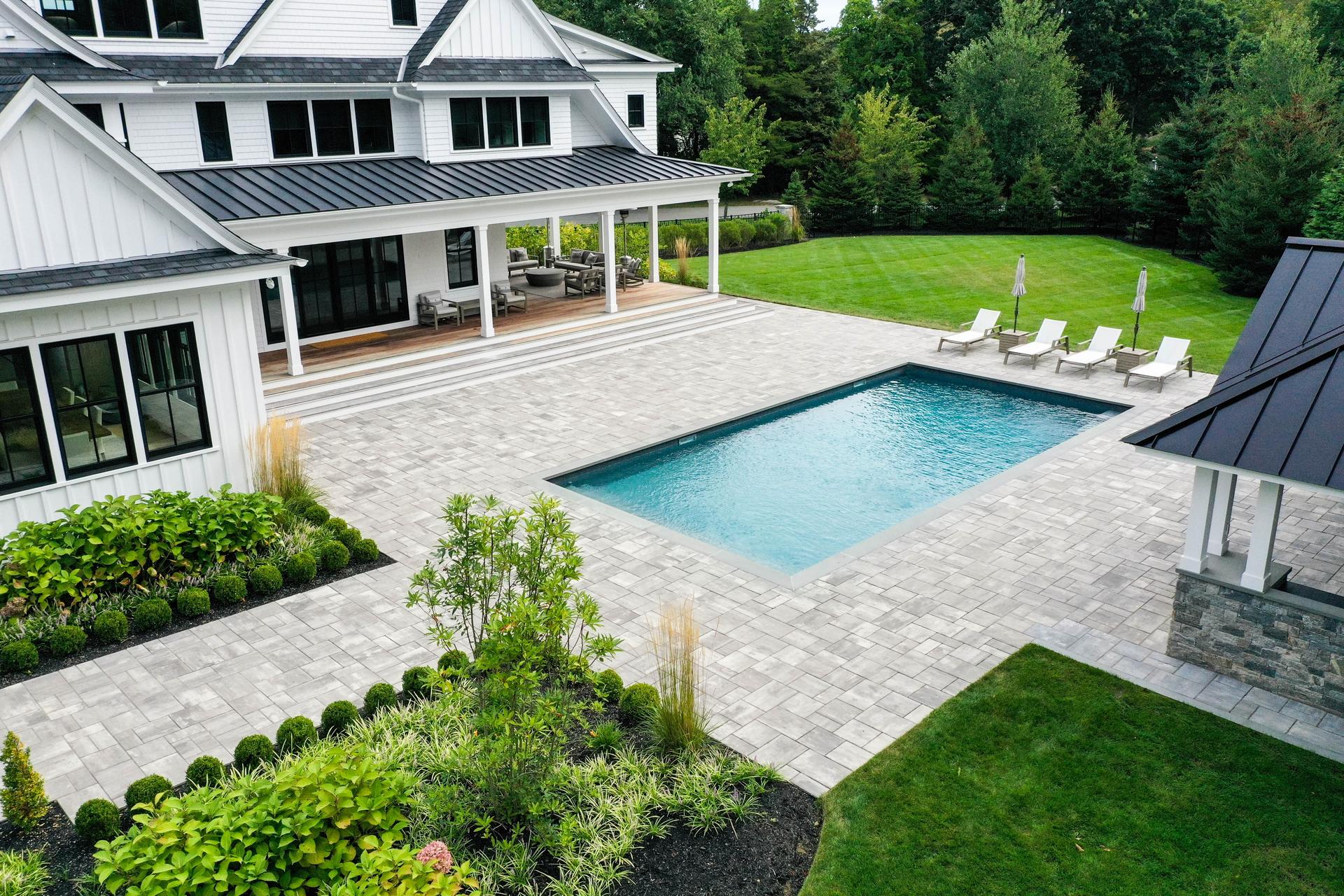 Completed custom backyard pool designed for Connecticut living