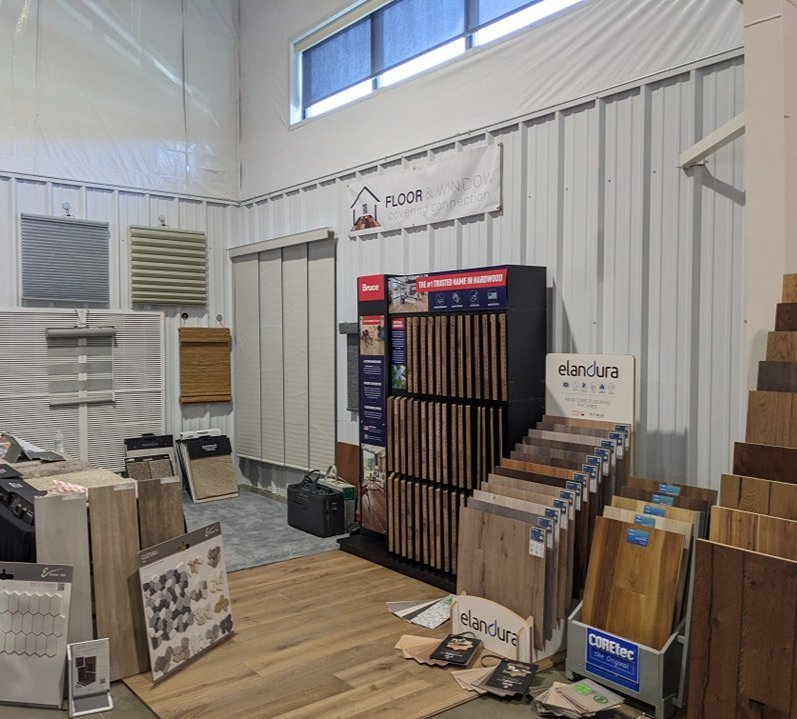 Flooring and window treatment showroom in Cañon City, CO featuring laminate, vinyl, hardwood samples, and blinds displays