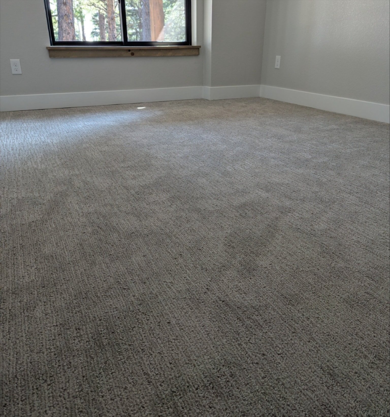 New carpet installation in a Cañon City, CO home, showing plush, neutral-tone carpet