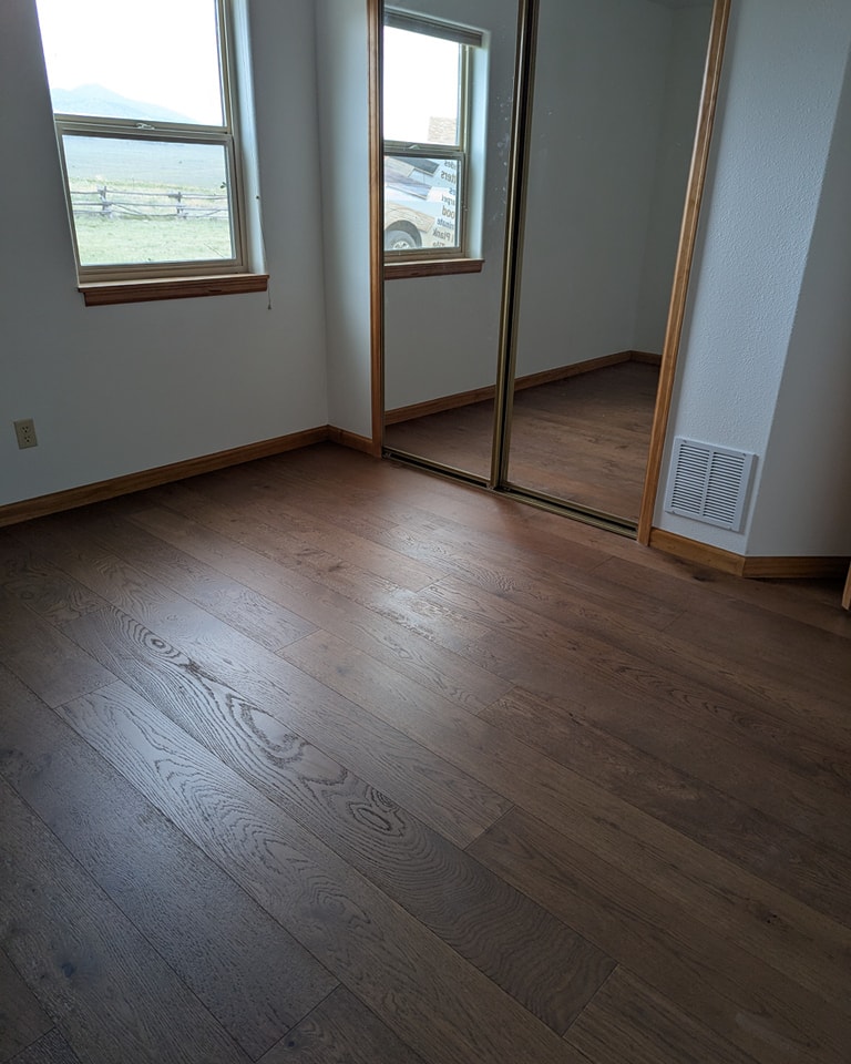 Bedroom in a Cañon City, CO home with newly installed hardwood flooring Bedroom in a Cañon City, CO home with newly installed hardwood flooring