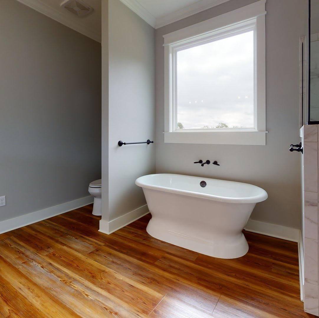 a bathroom with a tub and a toilet