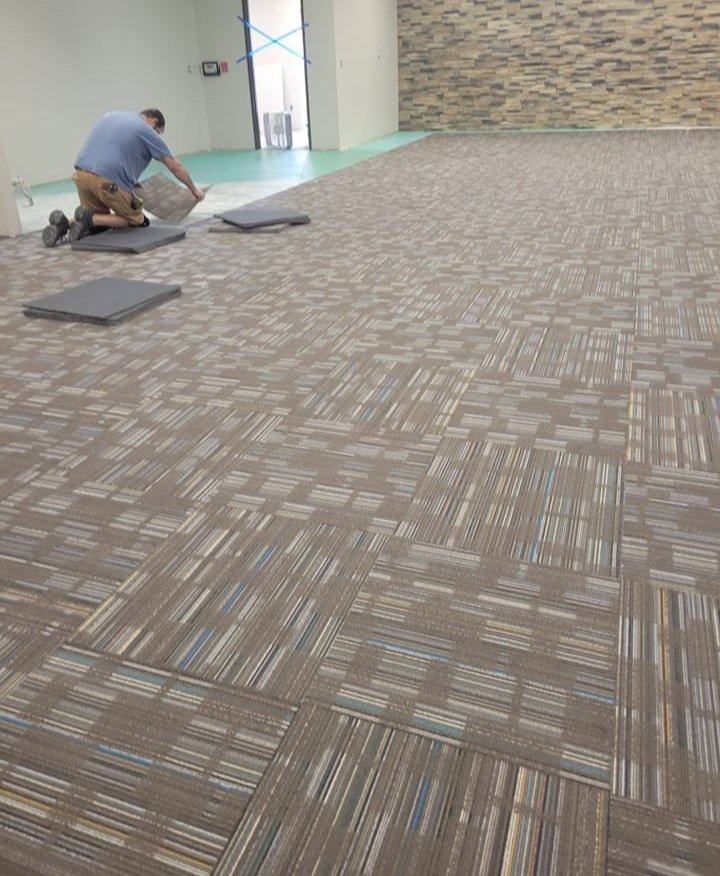 Professional carpet tile installation in a commercial space in Sallisaw, OK by Quality Floors