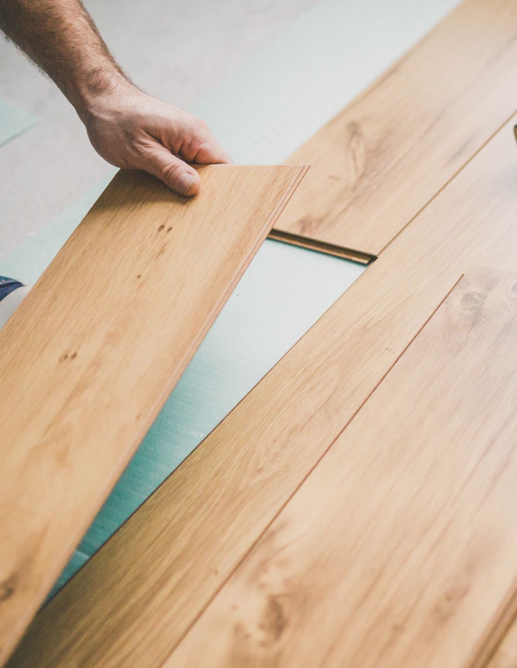 Skilled hands at work during the laminate flooring installation process