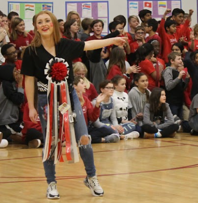 a senior with a mum whips up excitement during the pep rally