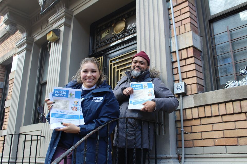 Two members of PEU holding Rent Freeze flyers