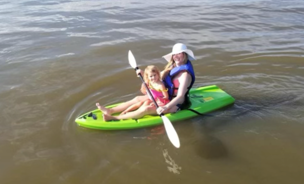 Colleen Davis paddling on the water with her daughter