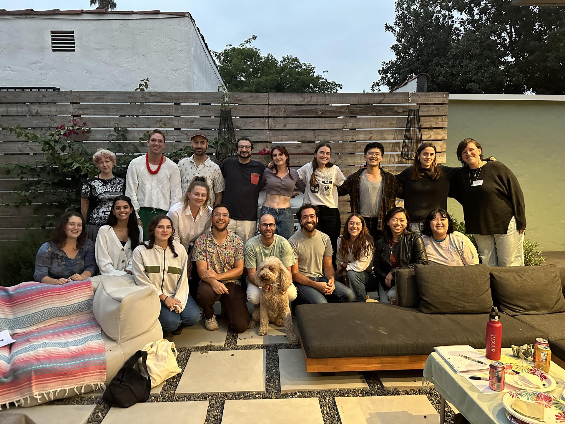 19 smiling RGLA members at the community meeting, and miso the dog!