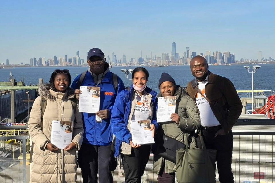 Picture of five PEU members holding flyers.