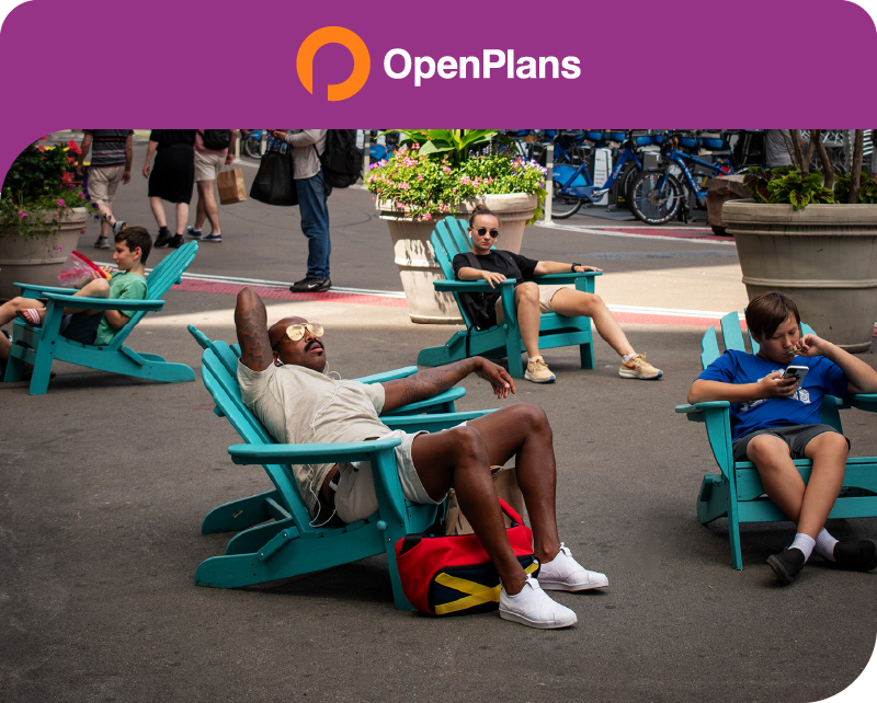 A picture of A couple of New Yorkers basking in the summer sun in a pedestrianized stretch of Broadway in the Flatiron District.