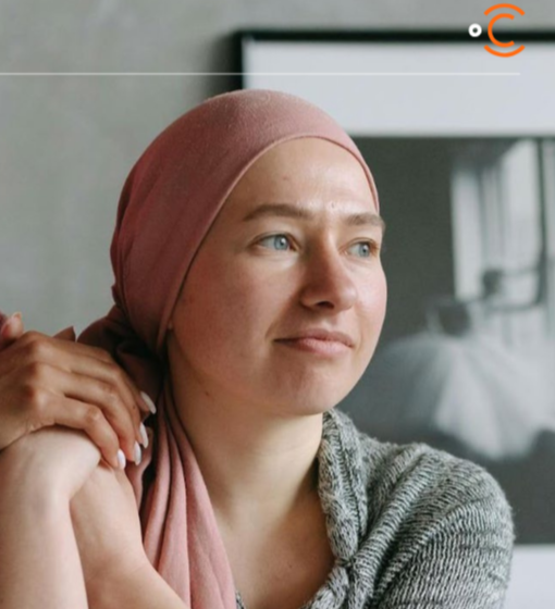 Profile image of woman with pink head scarf holding hands with another hand on her right shoulder