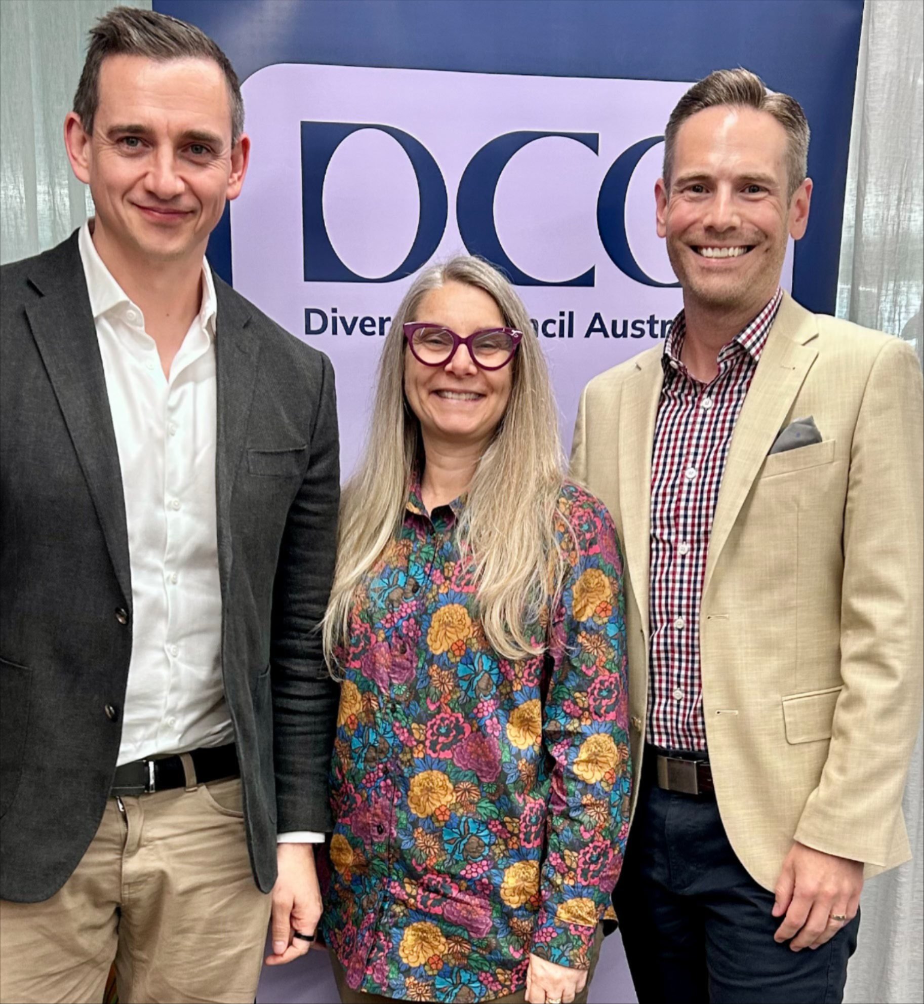 Arup’s David Kon and Abbie Wright with DCA Board Director Ian Goshko standing in front of a DCA banner in Adelaide