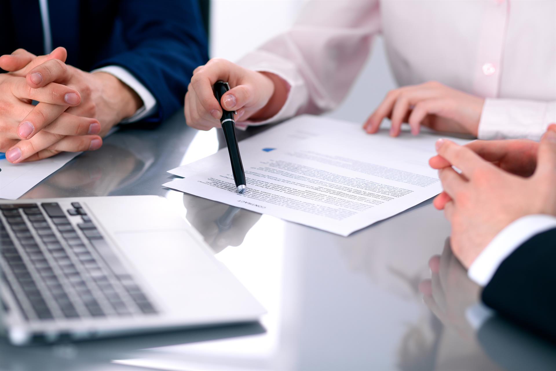 three professionals working on a document - stock photo