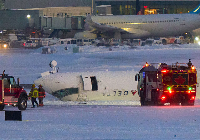Delta Airlines plane flips on landing in Toronto and a badly hurt child is among 8 casualties