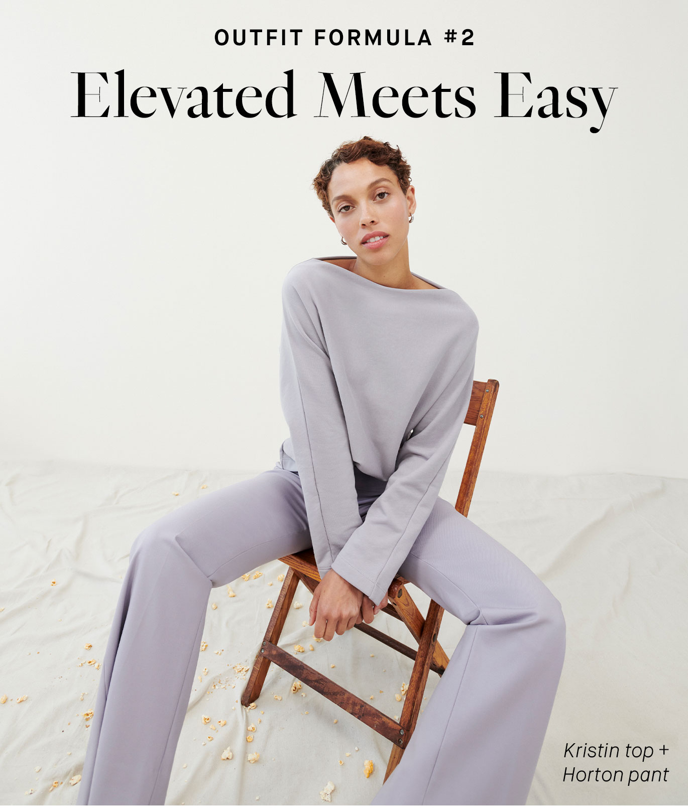 Image of a woman sitting in a wooden folding chair, wearing the Kristin top and Horton pant and lilac. Overlaid are the words ''Outfit Formula #2: Elevated Meets Easy''.