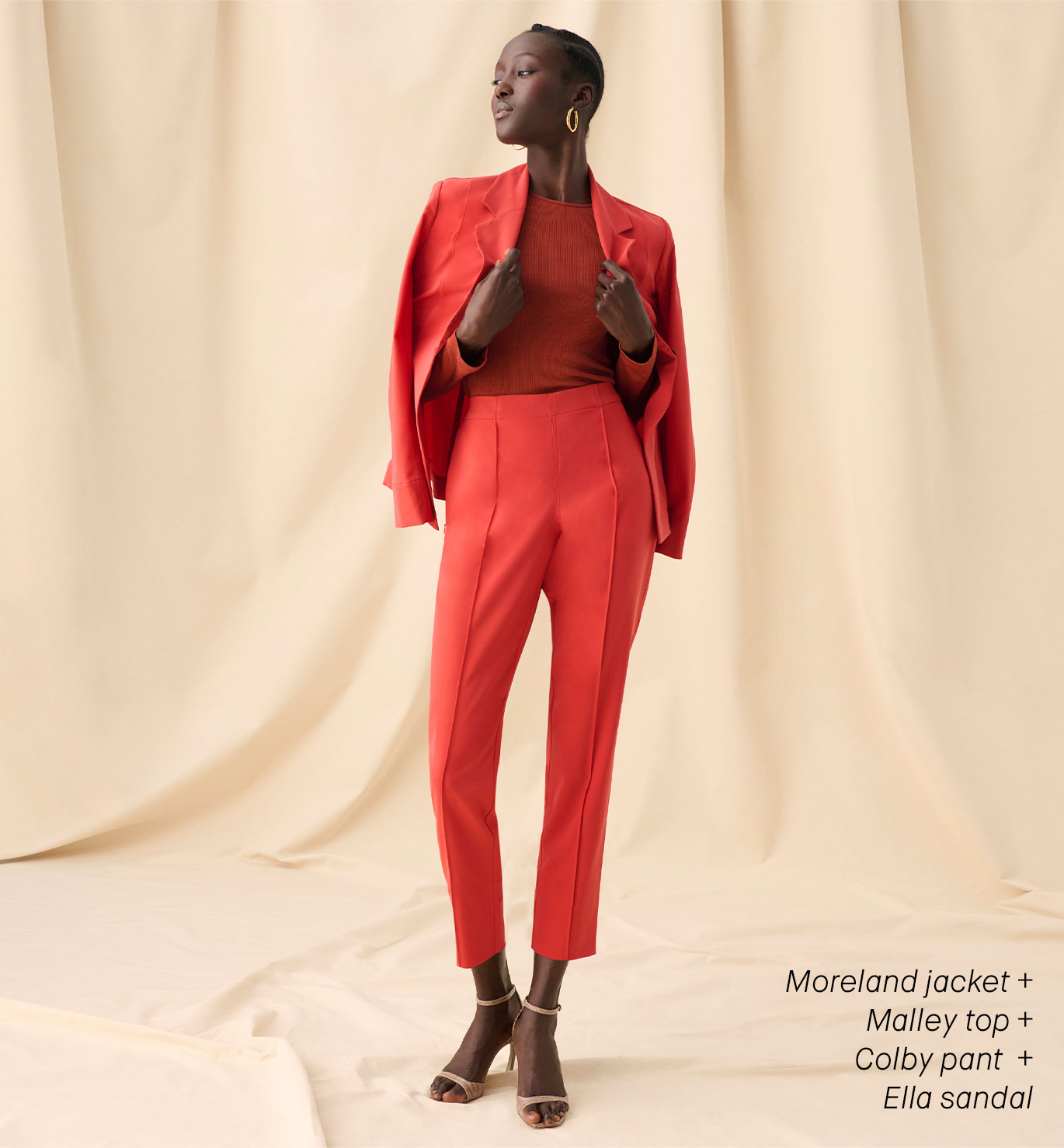 Image of a woman wearing a blood orange suit