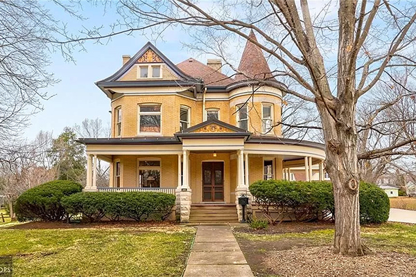 Yellow Victorian home with wrap around porch