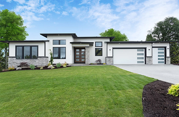 New construction modern home with large front lawn