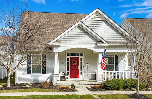 Craftsman home with red door and porch