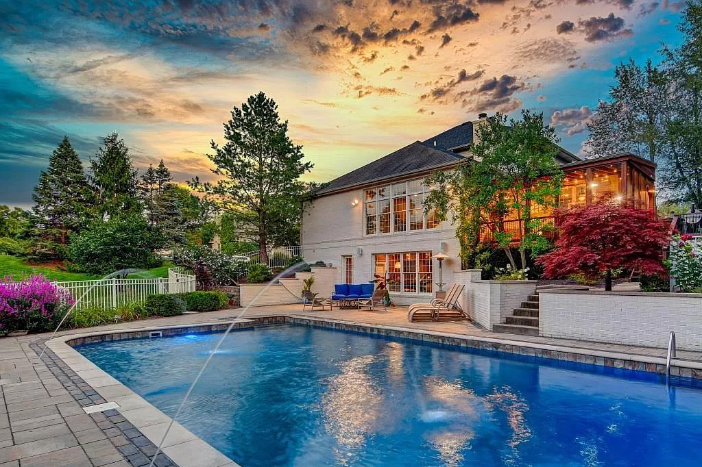 beautiful backyard with a large pool and green grass yard