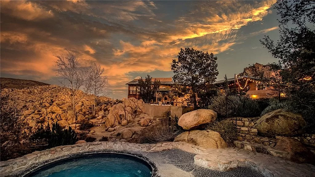 Desert oasis with a water hole and string lights