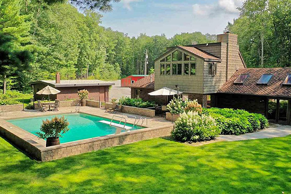 Home with a pool and lake in backyard