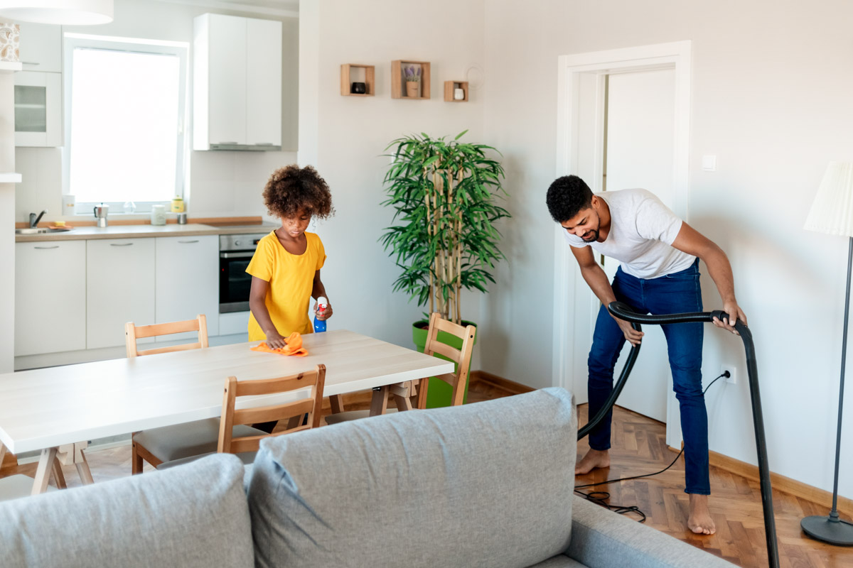 Parent and child in their house cleaning