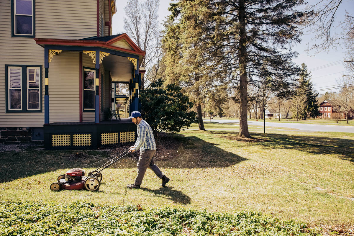 person mowing their lawn