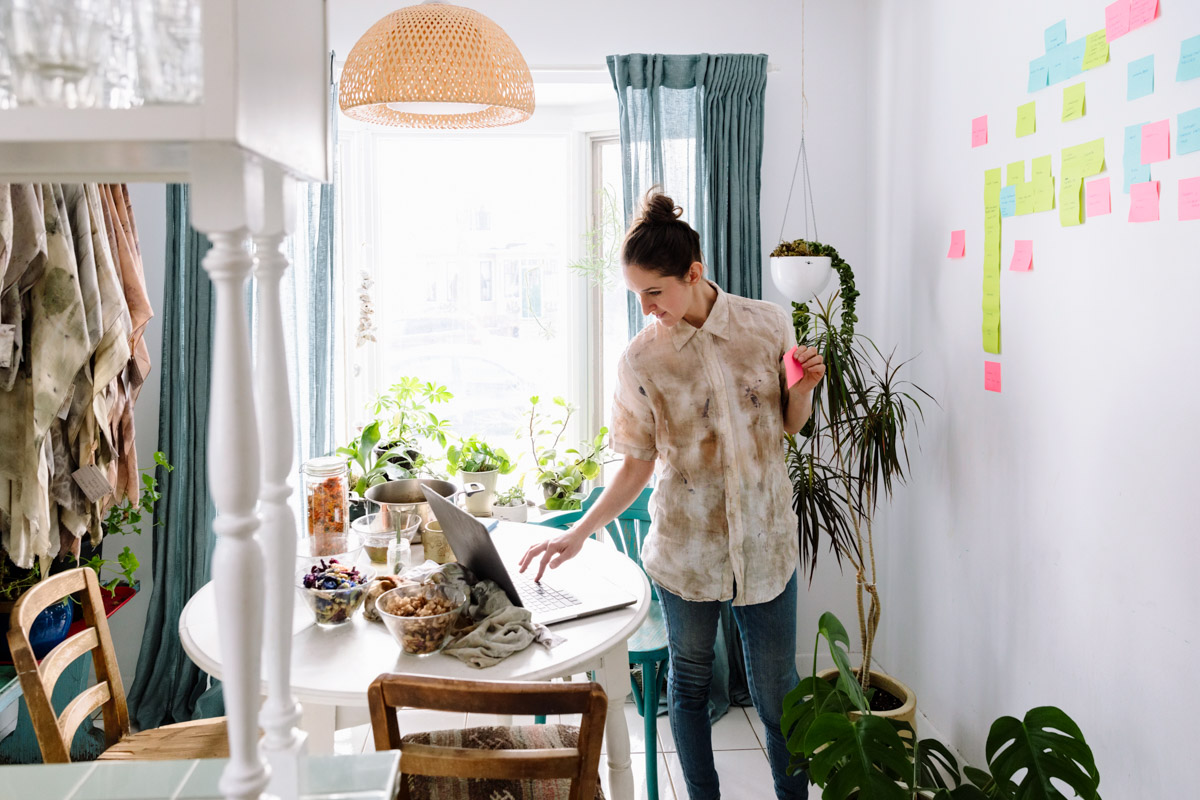 person in their apartment working on their laptop