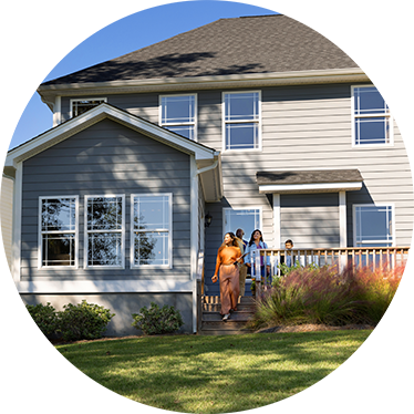 people standing in front of their house