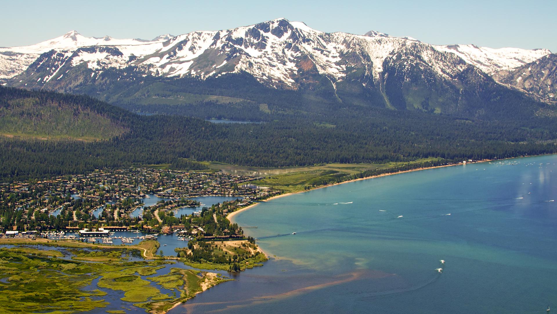 Town at the foot of the mountains by a lake