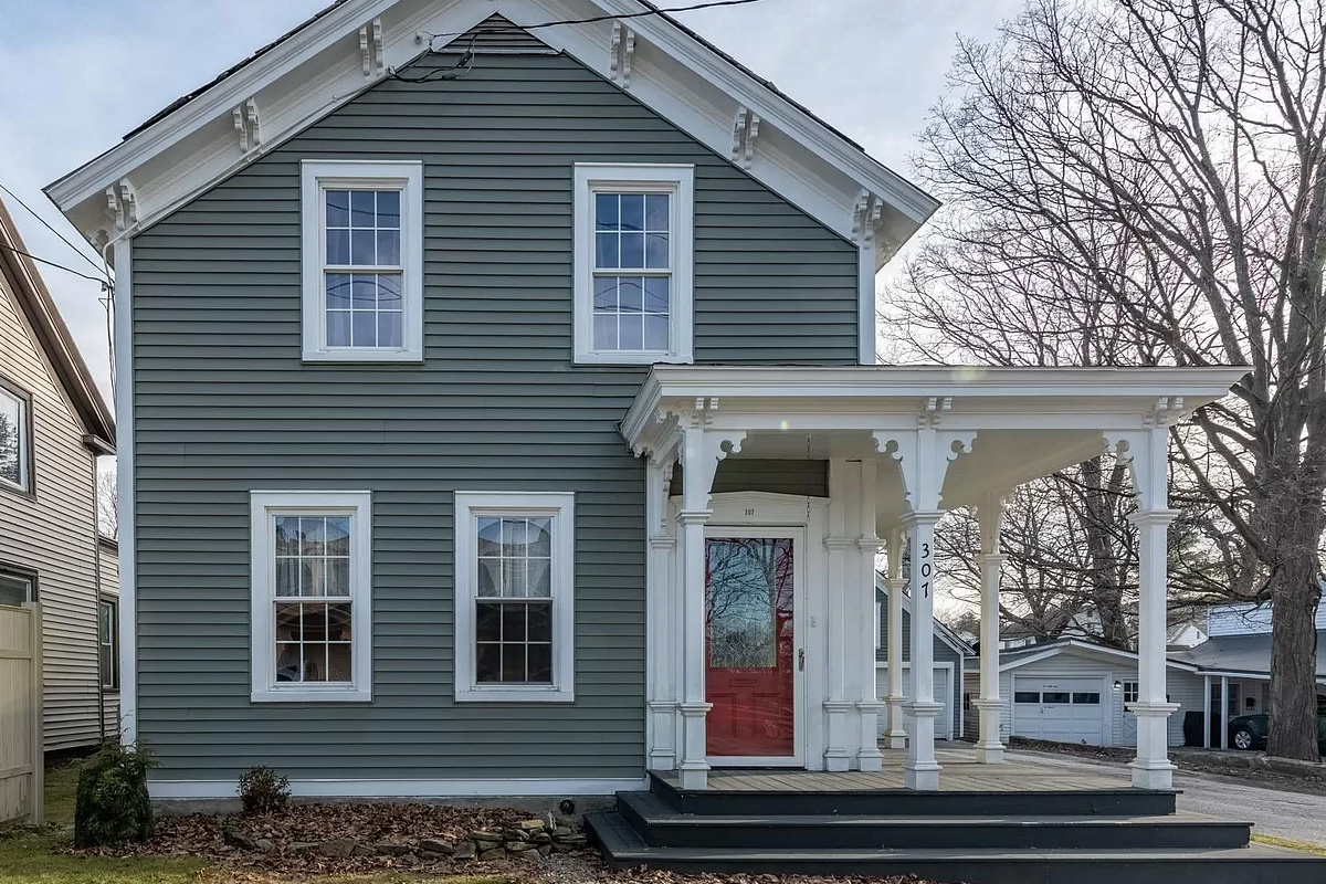 Beautiful house with a big front porch and red door