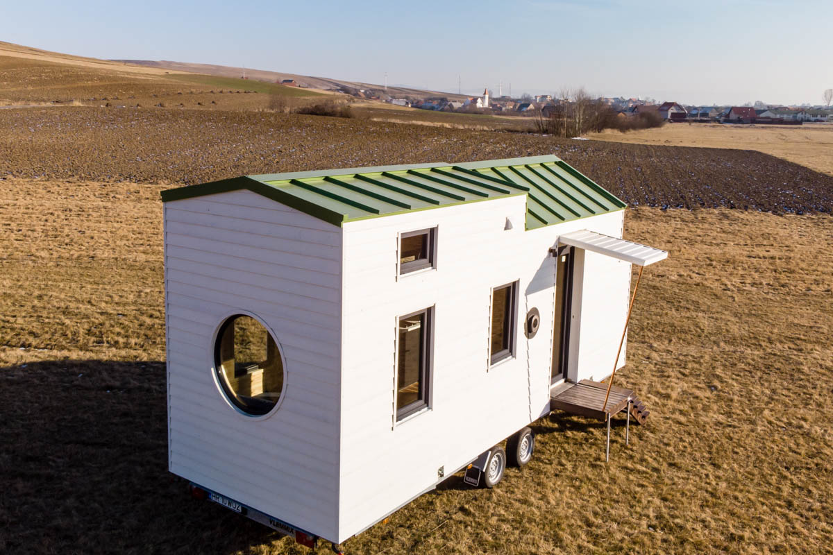 white tiny house in the middle of nowhere