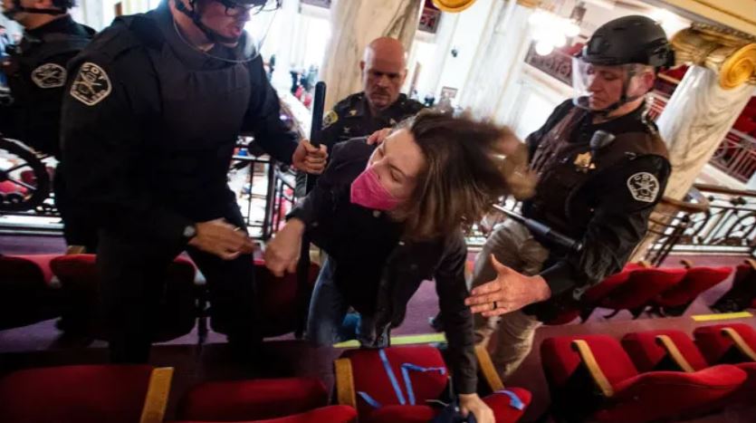 A protester getting arrested in the gallery of the House of Representatives