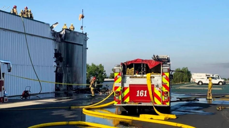 San Bernardino County Fire Department personnel respond to a small plane that crashed into a hangar at Cable Airport in Upland, Calif.