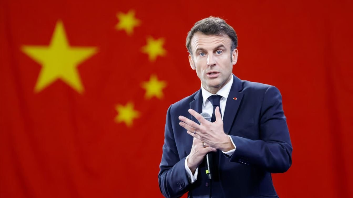 France's Macron in front of a Chinese flag