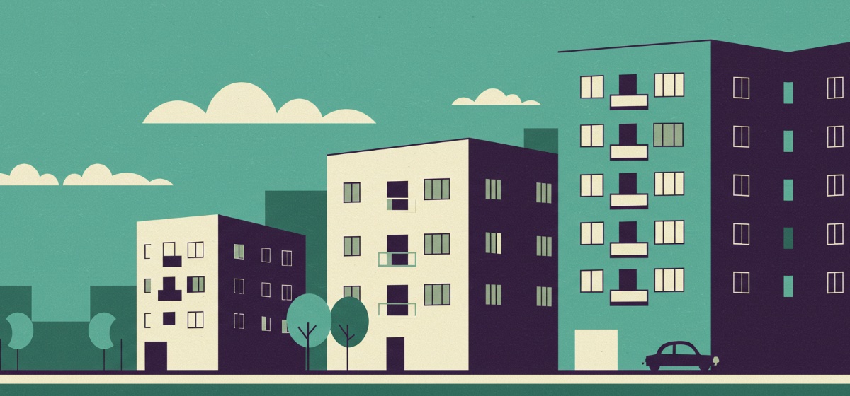 a row of apartment buildings on a quiet city street