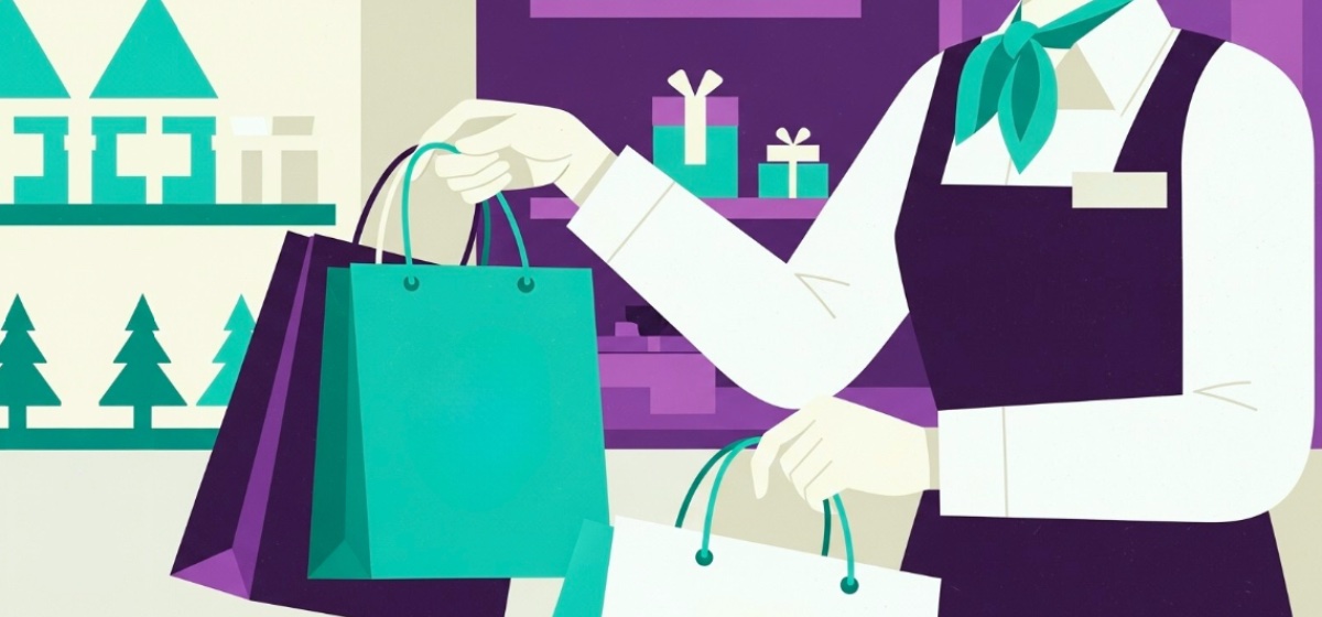 A retail clerk handing shopping bags to a customer