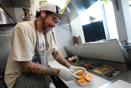 Cluck Truck worker making a sandwich