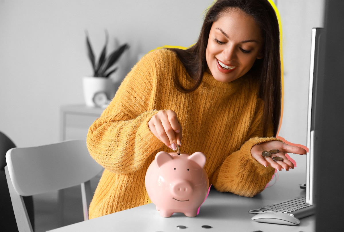 Woman putting coins into a piggy bank