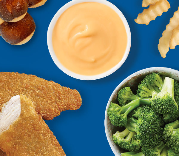 dipping cheese surrounded by broccoli, chicken tenders, pretzel bites, and french fries
