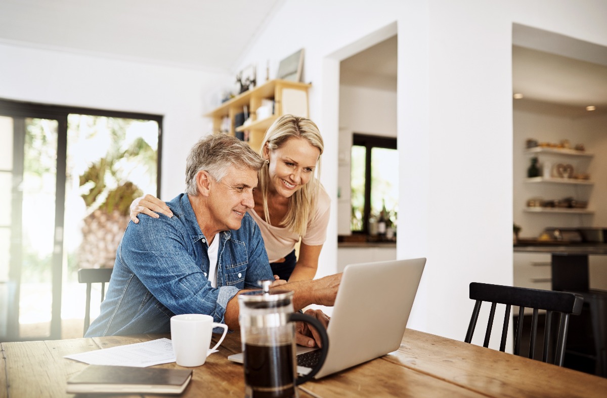 man and woman looking at a laptop