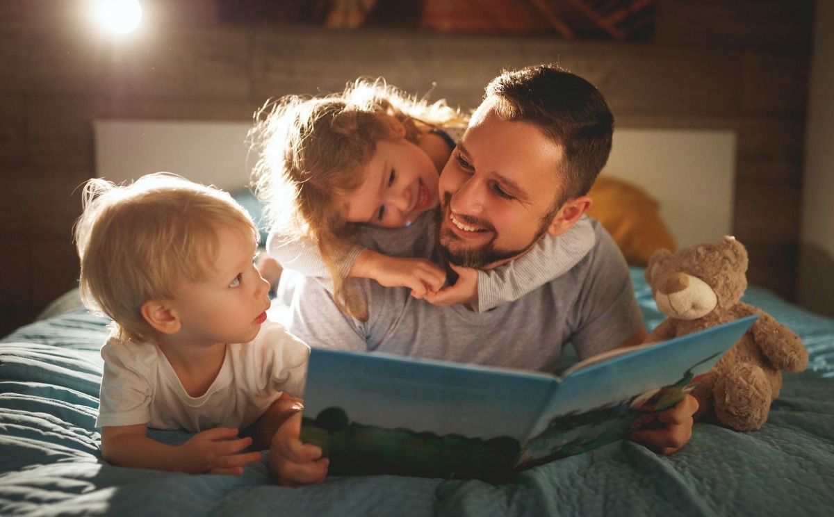 Man reading a story to his children