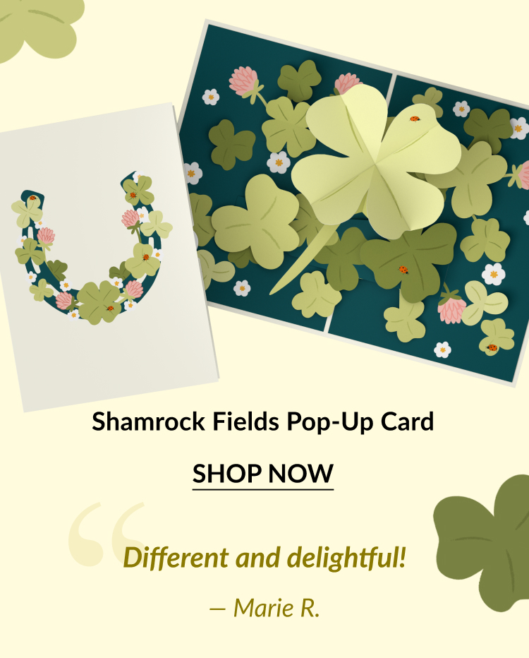 A pop-up card featuring vibrant green shamrocks, pink flowers, and ladybugs, set against a dark blue background. Shop now!