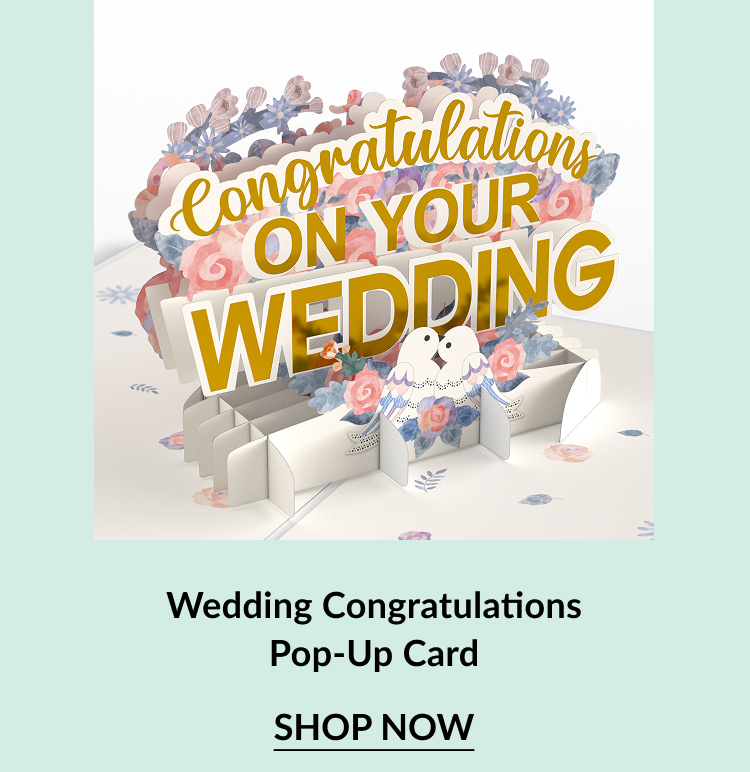 A colorful pop-up card featuring ''Congratulations on Your Wedding'' with floral accents and two doves, inviting viewers to shop now.