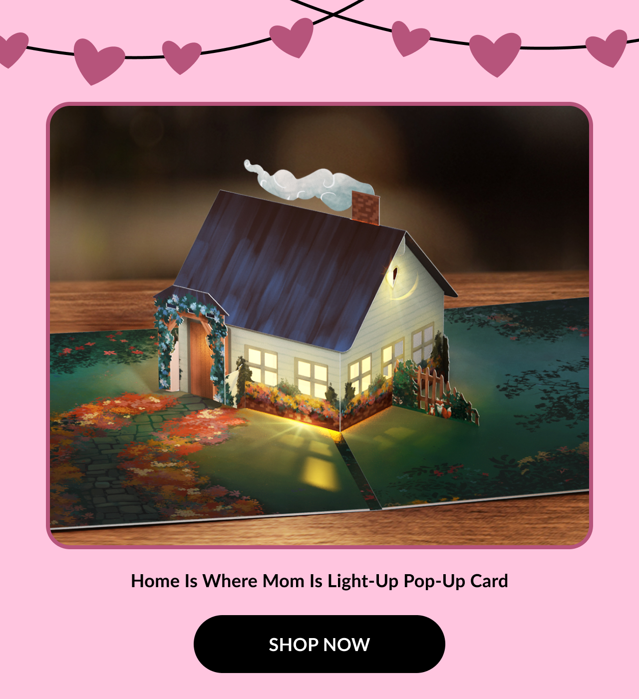 A charming pop-up card featuring a lit-up house surrounded by colorful autumn leaves, with a message celebrating home and family.